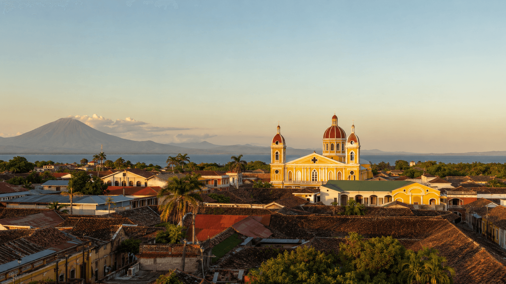 Granada, Nicaragua at golden hour — the yellow Cathedral of Granada in the foreground, cobblestone street leading to Lake Nicaragua with Mombacho Volcano in the background. The image evokes Nicaragua as a colonial-era retirement destination, though the formal retirement visa that drew foreign retirees here was repealed in August 2024.