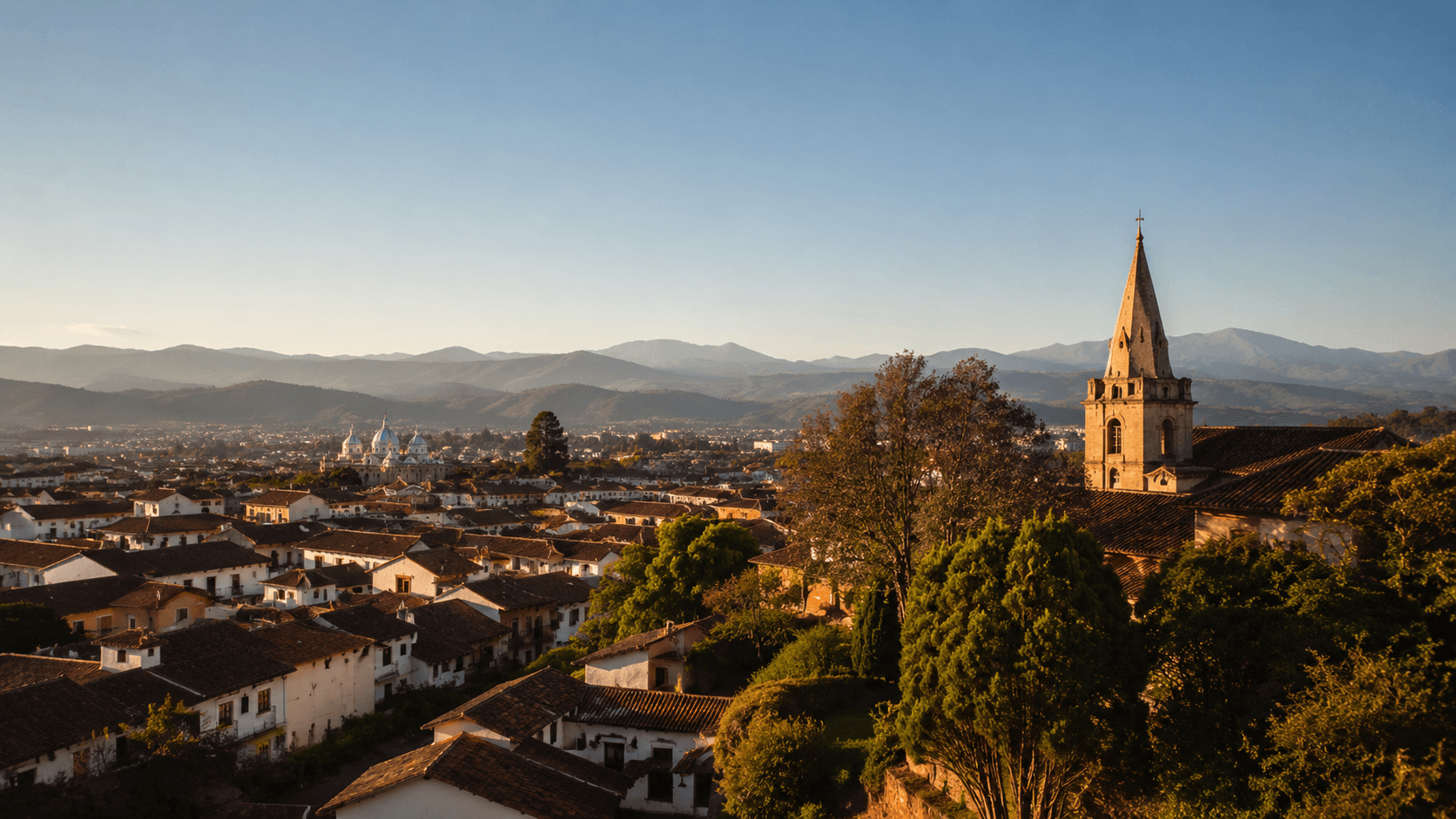 A colonial-era hillside town in Latin America at golden hour — terracotta rooftops, narrow cobbled lanes, a single church spire, distant Andes peaks. The image represents the actual relocatable destinations where a $1,500/mo retirement budget intersects with an active, accessible residence-permit pathway.